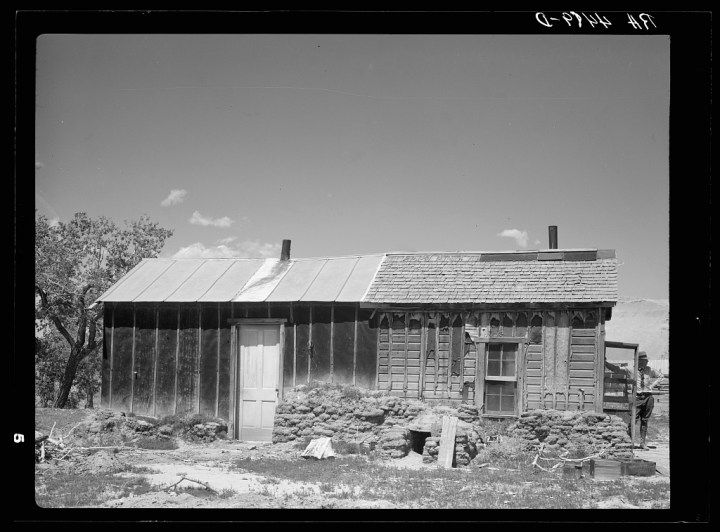 A broken down homestead on farmland.