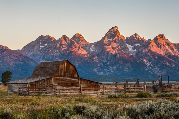 Sunrise at Mormon Row with T.A. Moulton barn and Teton range, Grand Teton National Park.