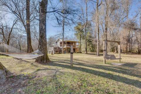 Reconnect With Nature At This Riverfront Cabin With An Absolutely Massive Deck In Mississippi