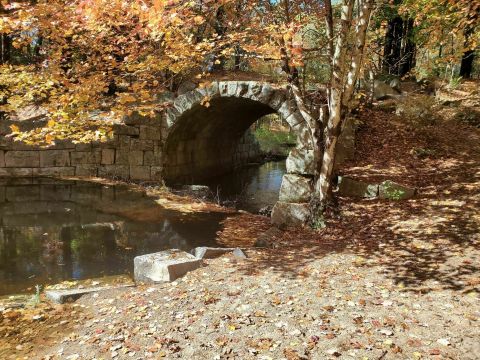 Wander Over An Old Stone Bridge At The Arched Bridge Conservation Area In Massachusetts