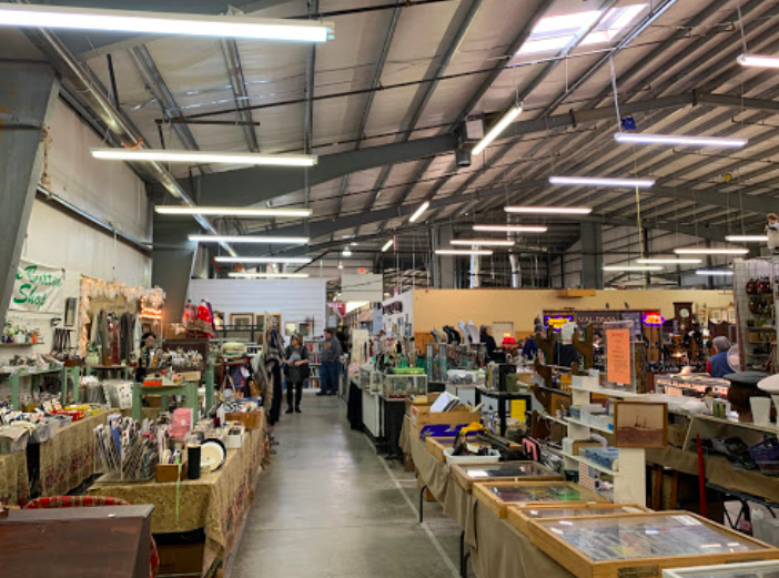 Large antique shop in Georgia with merchandise lining each side of the aisle.