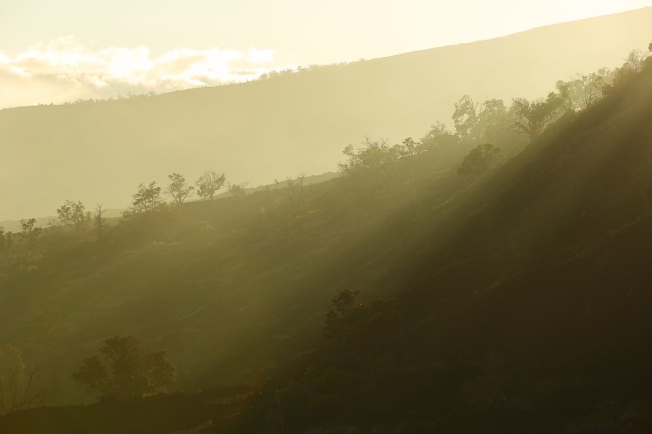 Sunlight and clouds filter light on the lava fields of Volcano National Park