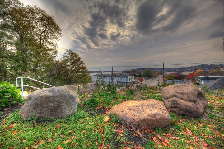 Hannibal Missouri Marion County Photo taken on November 6, 2019 Great River Road Series Climbing 244 steps to the top of Cardiff Hill one has a fantastic view of downtown Hannibal Missouri with a glimpse of the Mississippi River on the left just above the white structure at the corner. Looking south on Main Street the trees that line the path are in prime autumn foliage condition with multicolored leaves decorating the street.