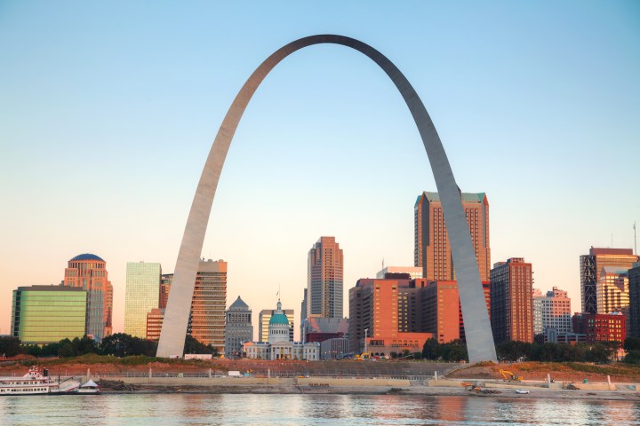 Downtown St Louis, MO with the Old Courthouse and the Gateway Arch at sunrise