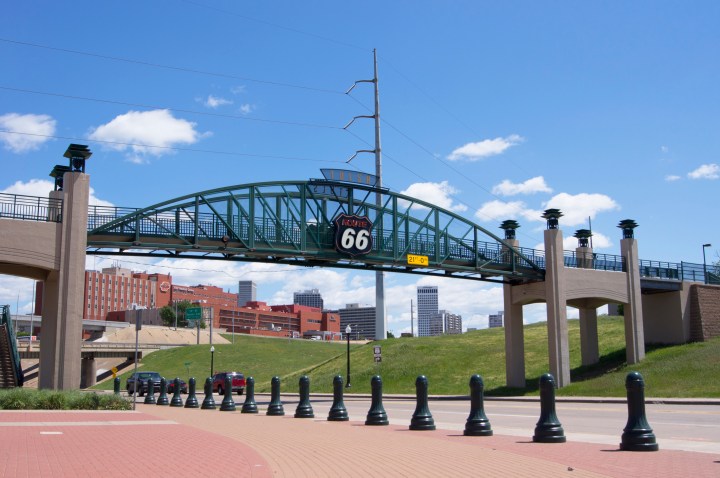 Pedestrian bridge at Cyrus Avery Centennial Plaza on Historic Route 66 in Tulsa, Oklahoma (Avery is known as the Father of Route 66), Tulsa is an attraction for Route 66 tourists in Oklahoma and the downtown area can be seen in the background