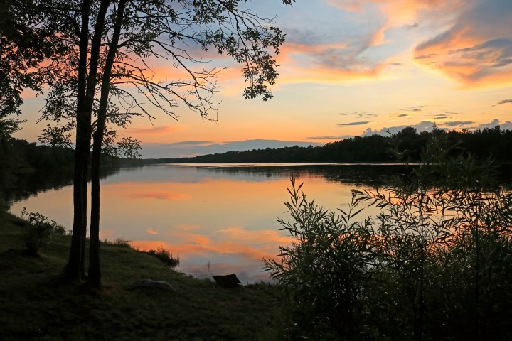 Sunset over the Rainy River in International Falls Minnesota with a view across the river to Ontario Canada