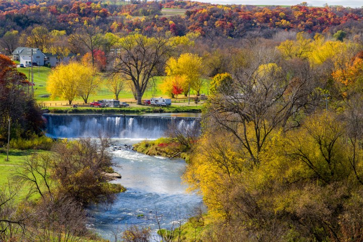 the root river spills over the lanesboro dam in picturesque lanesboro, minnesota, autumn.