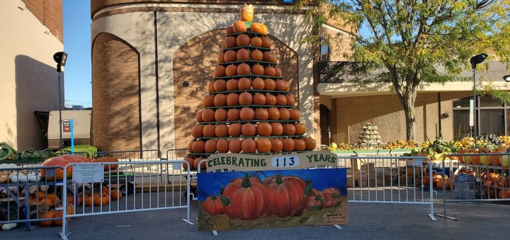 A pyramid of pumpkins with a banner that reads, Celebrating 113 years