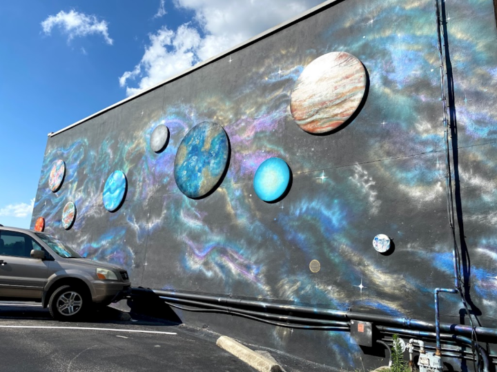 The mural Galactic Portal by Jessie Andrews is part of a secret trail in Alabama, the Downtown Huntsville Secret Art Trail.