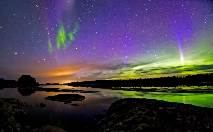 The Northern Lights glowing over the waters of Voyageurs National Park in Minnesota. The white light and wavy aurora are from the natural phenomenon known as Steve.