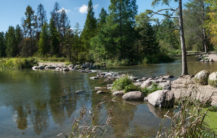 Water spills from the edge of Lake Itasca to begin the flow of the Mississippi River in northern Minnesota.