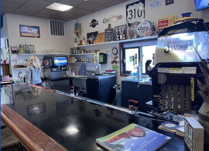 Interior of a country restaurant in Wyoming with a 310 sign on the wall.